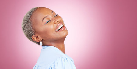 Makeup, laugh and young black woman in a studio with cosmetic, glamour and face routine. Happy, smile and African female model with a cosmetology facial treatment by pink background with mockup spaceの写真素材