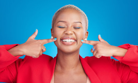 Happy, pointing and young black woman with cheek for smile in a studio with an excited or positive...