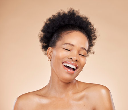 Skincare, beauty and black woman with eyes closed, excited and isolated on brown background in studio. Smile, natural cosmetics and African model in facial treatment for aesthetic, wellness or healthの写真素材