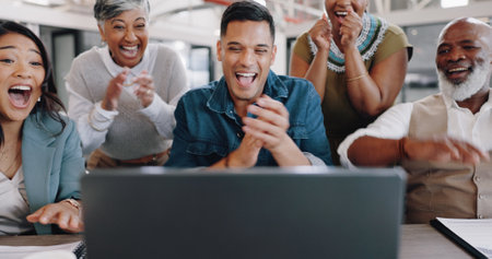 Business people, success and applause on laptop for winner or news of startup goals and marketing sales. Employees wow, celebration or clapping for social media target, winning or results on computerの写真素材