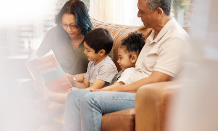 Home, story learning and student support with children and book for education. Studying, kid and grandfather with teaching, communication and reading for youth development and family in a houseの写真素材