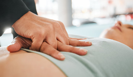 First aid, cpr and medical with hands on chest of patient for safety, heart rate and emergency service. Healthcare, wellness and support with closeup of people for accident, lifeguard and helpingの写真素材