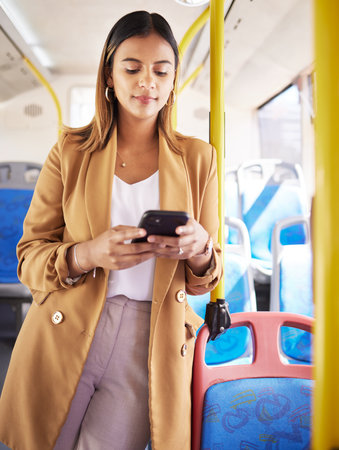 Bus, business woman and phone with public transport, social media scroll and web with job commute. City travel, stop and internet app of a female professional on a mobile with networking on metroの写真素材