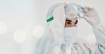 Man, face mask and PPE with goggles and safety, Covid compliance with mockup space and bokeh. Health, protection gear and virus with healthcare banner, disinfection and medical person with dangerの写真素材