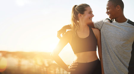Couple, fitness and banner with sun, hug and happiness outdoor, mockup space and wellness. Love, care and trust, interracial exercise friends and lens flare, smile with workout together and healthyの写真素材