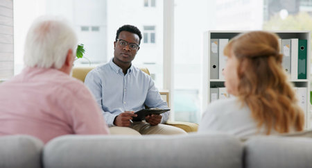 Senior, couple and therapy with psychologist for marriage consulting with advice and support. Communication, therapist and divorce talk with helping, listening and counselling for relationship issueの写真素材