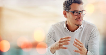 Communication, meeting and businessman in office with mock up space banner for advertising. Discussion, working and professional young male designer talking in workplace with mockup for marketing.の写真素材