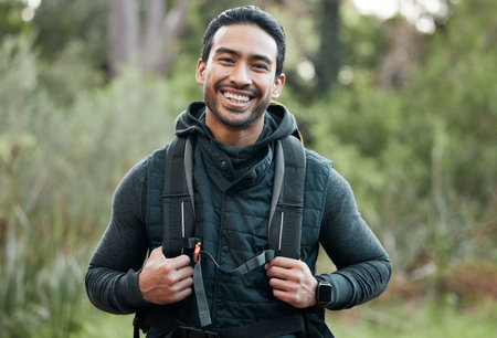 Man, backpack and portrait with smile, happy and camping travel in the forest for holiday. Exercise, trekking workout and hiking in the woods for vacation with freedom in nature on a journeyの写真素材