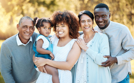 Smile, portrait and child with grandparents and parents in an outdoor park for adventure, holiday or...