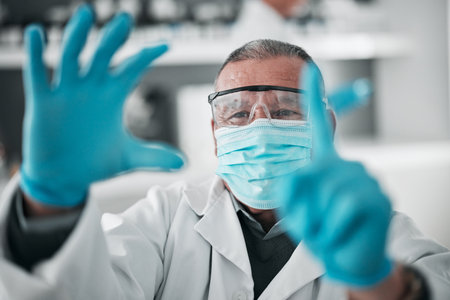 Medical, research and man with science, click and selection with mask, vaccine and healthcare. Senior person, researcher or scientist with gloves, futuristic and option with biotechnology or solutionの写真素材