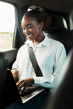 Laptop, smile and black woman typing in car to travel, reading email for remote work and social...
