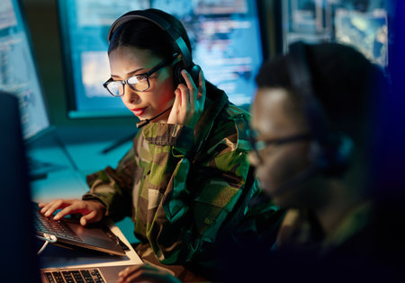 Military control room, headset and woman with communication, computer and technology. Security, global surveillance and soldier with teamwork in army office at government cyber data command center.の写真素材