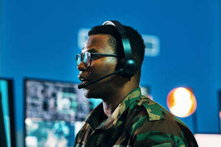 Military, call center and man on computer in office, data center and monitor for technical support, cybersecurity or surveillance. Army, officer and work in tech, security or government communicationの写真素材