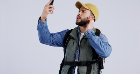 Phone, service or signal with a hiking man in studio on a gray background searching for reception....