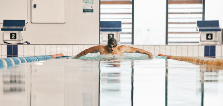 Swimming exercise, pool and sports man doing water challenge, cardio training or butterfly stroke...