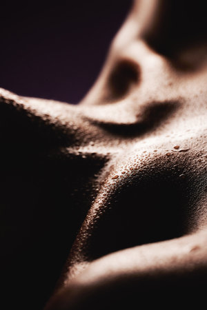 Skin, water and a body closeup in studio for beauty, wellness or feminine hygiene and care. Luxury, aesthetic and skincare with a person in the salon during sweat or hydration treatment for healthの写真素材