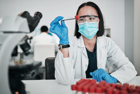 Scientist, blood test and woman in laboratory with face mask for studying medical analysis,...