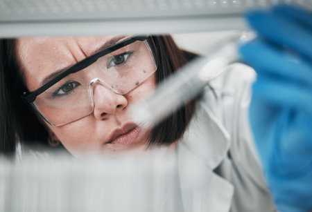 Test tubes, scientist and woman with investigation, thinking and science research of an Asian person. Laboratory, professional and healthcare worker with medicine and liquid check for hospital testの写真素材