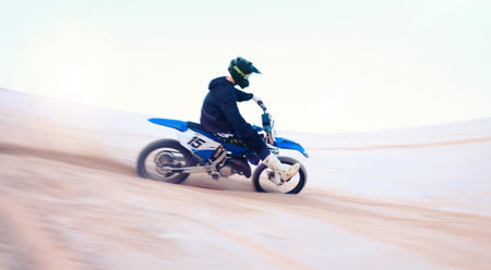 Sports, desert and athlete on motorbike for action, adrenaline and skill training for challenge,...