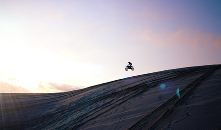 Motorcycle, person and jump for training or sports with fitness, balance or challenge in nature on mock up space and sky. Bike, freedom and adventure for competition, exercise or talent in desertの写真素材