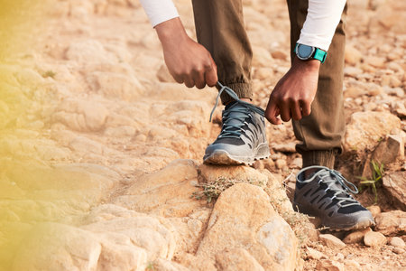 Tie, mountain or hands of hiker with shoes for fitness training, exercise or outdoor workout. Lace,...