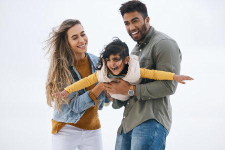 Airplane, sky background or child with parents playing for a family bond with love, smile or care. Mom, flying or happy Indian dad with a girl kid to enjoy fun outdoor games on a holiday togetherの写真素材