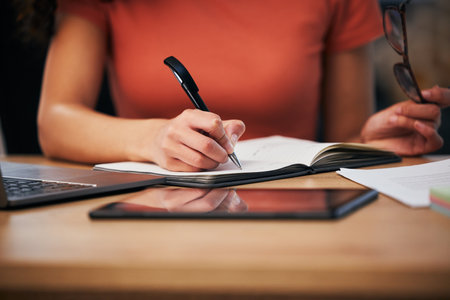 Notebook, office and hands of person writing summary notes, schedule or event planner working on appointment calendar. Project, closeup secretary and receptionist planning agenda, journal or reportの写真素材