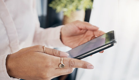 Hands, tablet and closeup for business woman, planning app or reading email notification in office. Entrepreneur, employee and digital touchscreen with data analysis, contact or schedule in workplaceの写真素材