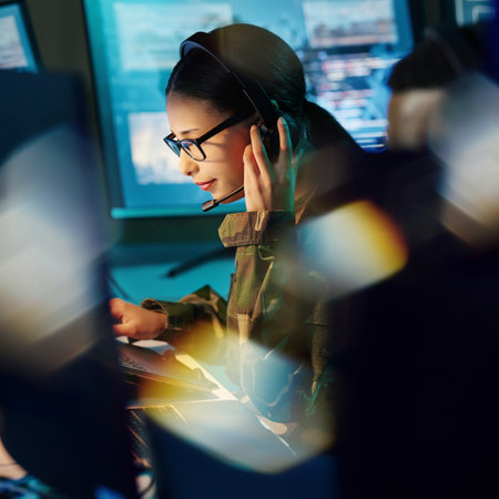 Military command center, headset and woman with communication, computer and technology. Security, global surveillance and soldier with teamwork in army office at government cyber data control room.の写真素材