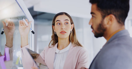 Business people, glass board and partnership for writing, sticky note or tablet for talk, teamwork or planning. Businessman, female partner and moodboard for goal, ideas or brainstorming for strategyの写真素材