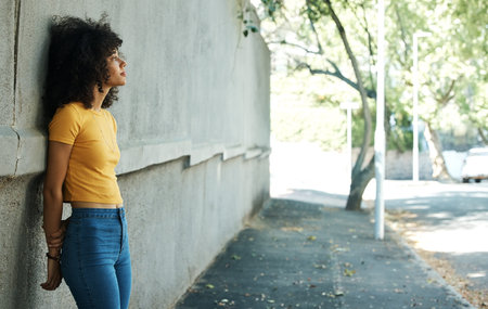 Thinking, woman and city wall on a road with travel and outdoor sad from memory with mockup space. Female person, sidewalk and depression on a urban street with grief, disappointed and mental healthの写真素材