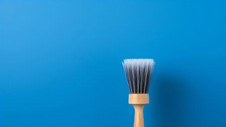 Wooden brush on blue. Clean home and kitchen copyspace backgroundの素材