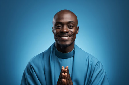 Studio portrait of african priest against blue backdrop. Religion concept.の素材