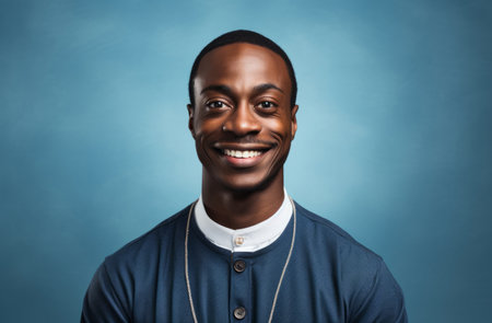 Studio portrait of african priest against blue backdrop. Religion concept.の素材