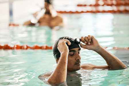 Swimming pool, man and sport athlete for workout and training race in professional gym. Male person, fitness and exercise for water competition in a health and wellness club for pool and athleteの写真素材