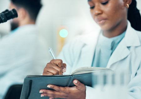 Results, black woman or scientist writing research notes for analysis on experiment or medical information. Notebook, biologist or expert in a laboratory with documents info for science developmentの写真素材