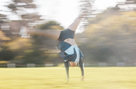Cheerleader routine, cartwheel and field person exercise, action and training for sports...