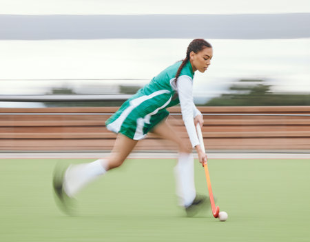 Hockey, sports or woman running in game, tournament or competition with ball, stick or action on turf. Blur, training or fast girl player in exercise, workout or motion on artificial grass for speedの写真素材