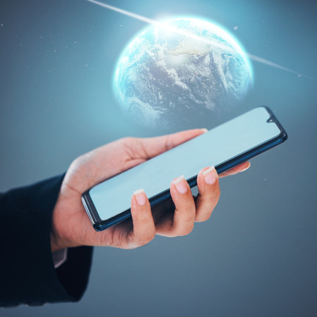 Person, hands and phone with 3D globe, mockup screen or hologram for global communication or networking. Closeup of user holding mobile smartphone display for social media world or internet serviceの写真素材