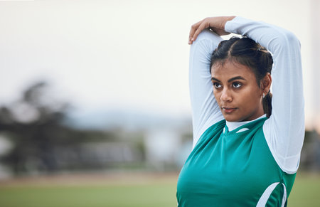 Thinking, stretching and a woman hockey player getting ready for the start of a game or competition outdoor. Sports, fitness and warm up with a young athlete on a field for a training workoutの写真素材