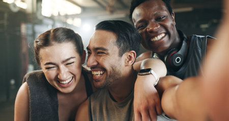 Selfie, funny face and fitness with friends at gym for social media, workout and health. Support, profile picture and wellness with people and training for teamwork, photography and exercise togetherの写真素材