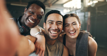 Gym friends, group selfie and face with peace sign, funny joke and health for post on web blog. Men, woman and fitness team with photography, comic video and exercise with social media live streamingの写真素材