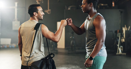 Teamwork, friends and fist bump with people in gym for motivation, support and workout. Personal...