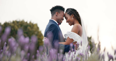 Wedding, bride and groom hug in a field, dancing and celebration of love with happiness and commitment. Marriage, trust and black people in relationship, event and nature with love and care outdoorの写真素材