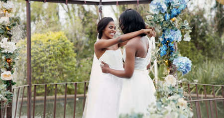 Wedding, lesbian and women dancing outdoor together at ceremony for celebration, happiness and romance. Marriage, love and lgbtq people embracing and moving with smile in elegant dress in natureの写真素材