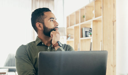 Business, thinking and man with a decision, laptop and choice with a creative project, solution and problem solving. Person, employee and consultant with a pc, brainstorming and planning with ideasの写真素材