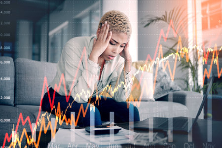 Woman, overlay and stress of home budget, stock market crash and lines chart, bills or money risk. African person with depression, sad or tired on computer for loan payment, trading or cost of livingの写真素材