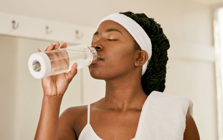 Tennis, health and woman drinking water, fitness and tired with workout, fatigue or exercise....