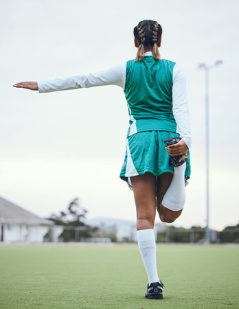Back, sports and a woman hockey player stretching for the start of a game or competition outdoor....