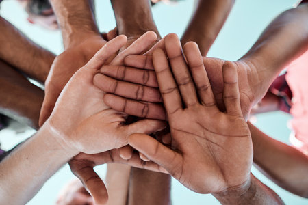 People, teamwork and hands together in motivation, collaboration or community for goals below. Closeup of group piling in team building, solidarity or trust in support for sports, rugby or matchの写真素材